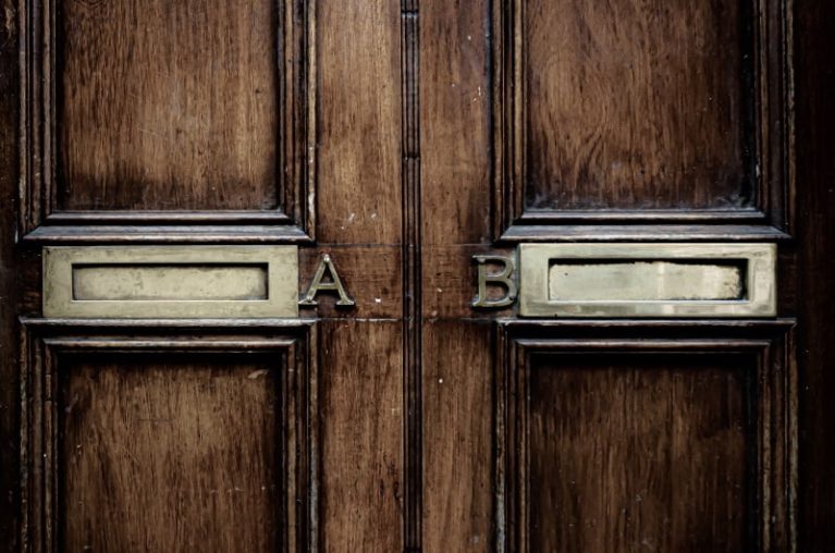 Two letter boxes on a brown door labelled A and B