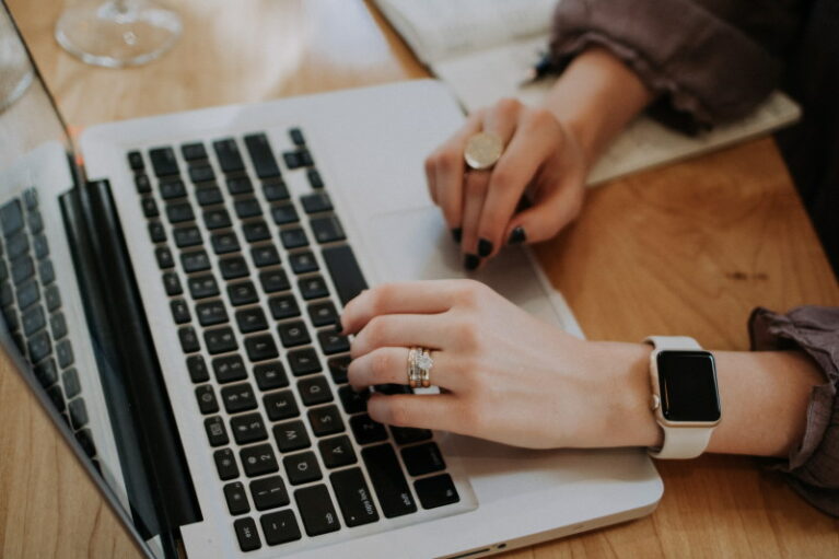 Shot of a woman's hands typing on MacBook